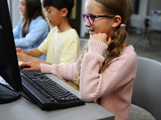 Students looking at a computer