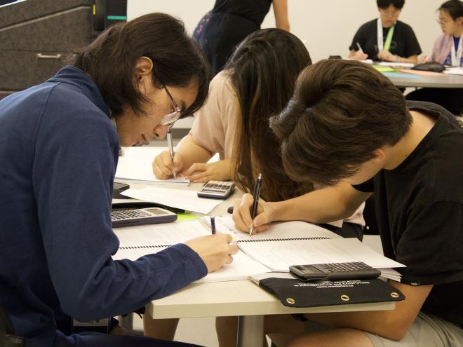 Students collaborating over math summer courses