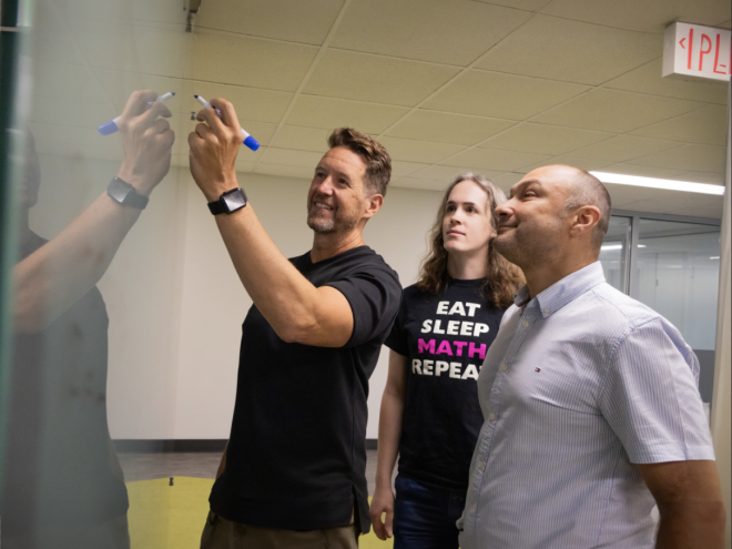 Group of educators working together on a whiteboard