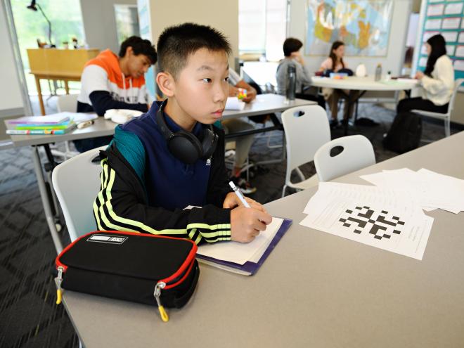 Student taking notes in the classroom